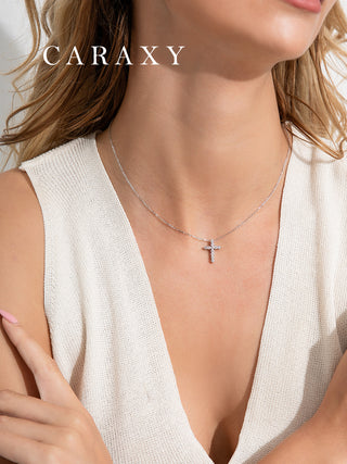 Model wearing a dainty lab grown diamond cross necklace in 18K white gold for an everyday minimalist look.