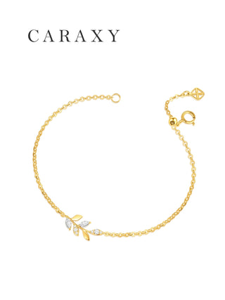 Angled view of a dainty leaf bracelet in 18K yellow gold with marquise and round lab grown diamonds.