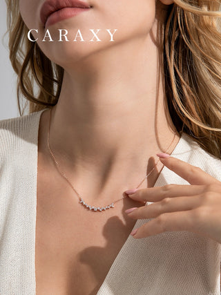 Model wearing a dainty leaf-inspired diamond necklace in 18K rose gold with lab grown diamonds, styled as elegant everyday jewelry.