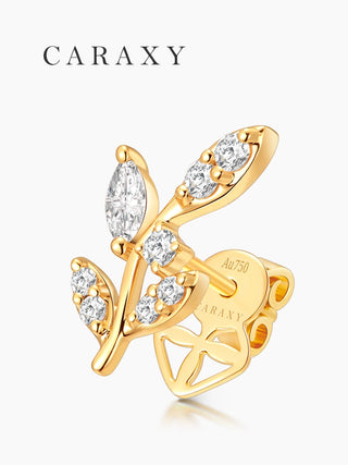 Model wearing delicate leaf diamond studs in a close-up ear view.