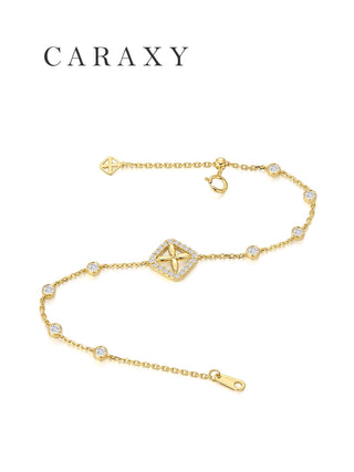 delicate gold bracelet with clover diamond motif laying flat