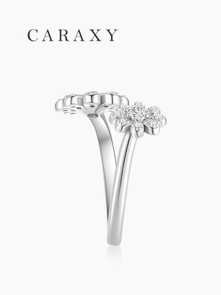 Side view of diamond double flower open ring showing the floral bypass setting and polished sterling silver band.