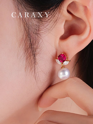 Close-up of a red gemstone diamond and freshwater pearl drop earring worn on the ear