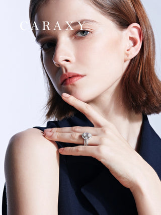 CARAXY emerald cut diamond ring set worn on hand, featuring pear shaped and round diamond accents