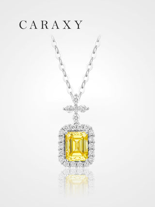 Emerald cut fancy yellow lab grown diamond halo pendant necklace in 18K white gold with a cable chain.