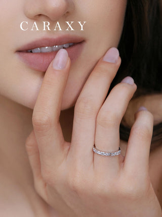 Model wearing emerald-cut and round diamond band.