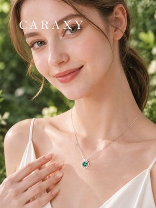 Woman wearing an emerald diamond butterfly necklace in 18K white gold