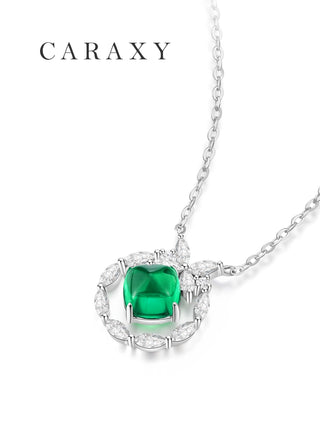 Close-up of a Muzo-green sugarloaf emerald pendant surrounded by marquise and round lab grown diamonds