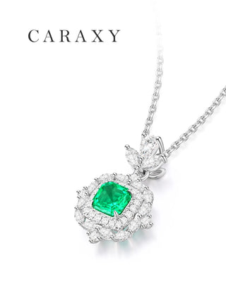 Close-up of a muzo-green gemstone surrounded by round, marquise and pear-shaped lab grown diamonds