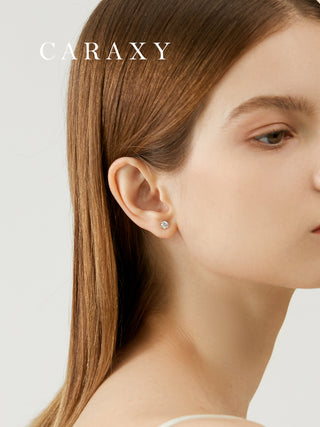 Everyday diamond studs shown on model with clean natural styling.