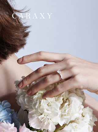 Twist band solitaire engagement ring worn on finger showcasing a refined everyday look.