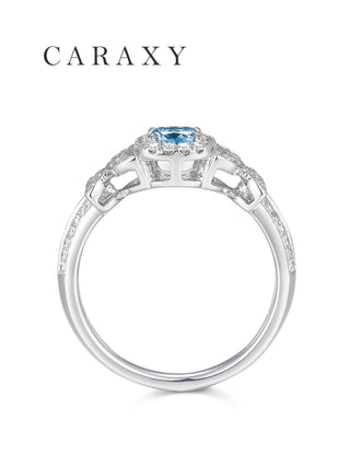 Side profile of the 18K white gold blue diamond ring showing the intricate butterfly wing filigree under the setting.