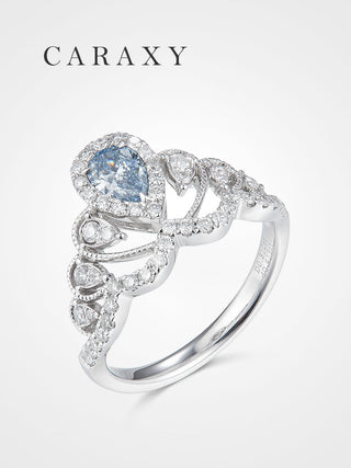 A luxurious fancy blue diamond statement ring featuring a pear-shaped center stone.