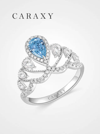 A luxurious fancy blue diamond statement ring featuring a pear-shaped center stone.