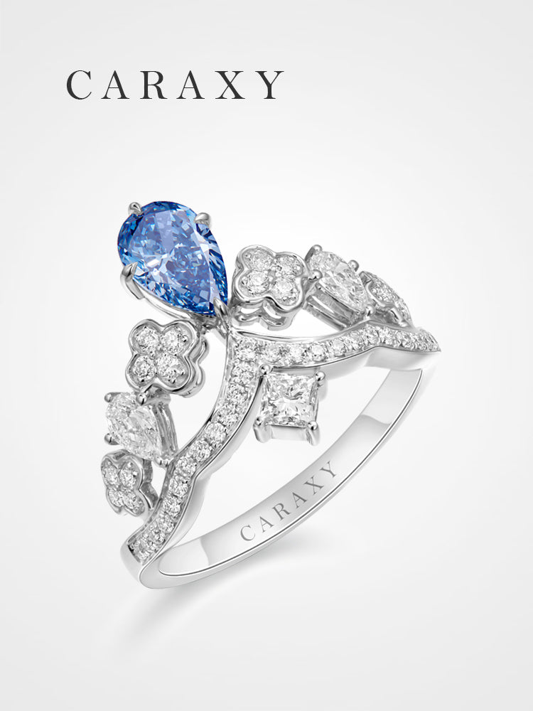 A unique fancy blue diamond tiara ring featuring a dangling pear-shaped diamond.