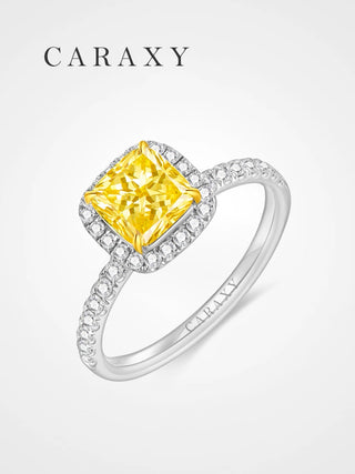 Fancy vivid yellow diamond engagement ring with a cushion cut halo setting.