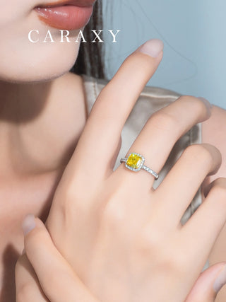 Lifestyle view of a model wearing a luxurious fancy vivid yellow diamond halo ring.