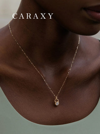 Model wearing a minimalist gold kettlebell necklace designed for fitness lovers.