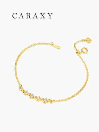 Detail of a five-stone lab grown diamond bracelet with adjustable sliding bead and spring ring clasp in 18K yellow gold.