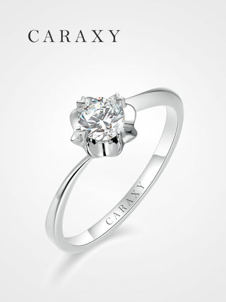 A minimalist floral solitaire engagement ring with a unique bypass shank design.