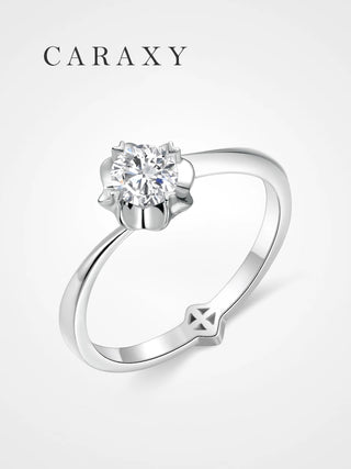 A minimalist floral solitaire engagement ring with a unique bypass shank design.