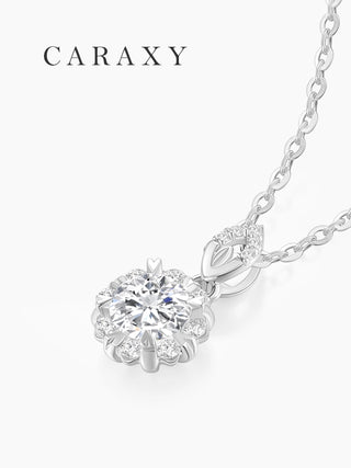 Angled view of a floral diamond necklace with a round center stone surrounded by 8 round brilliant diamonds.