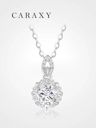Front view of a floral diamond necklace with a round center stone framed by 8 round brilliant diamonds.