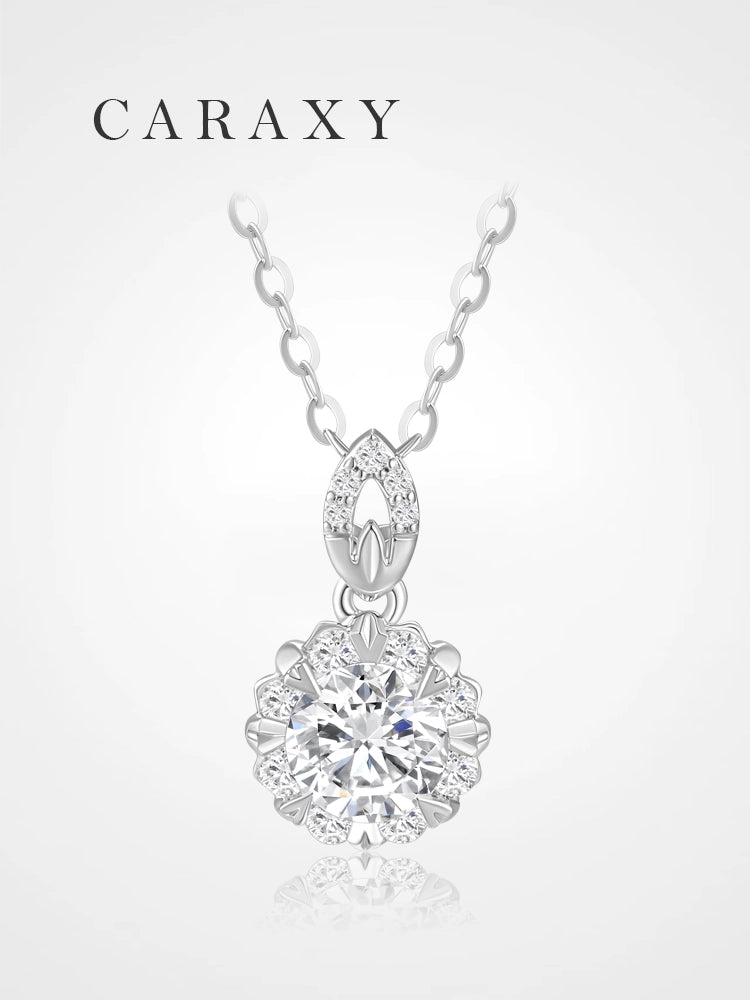 Front view of a floral diamond necklace with a round center stone framed by 8 round brilliant diamonds.