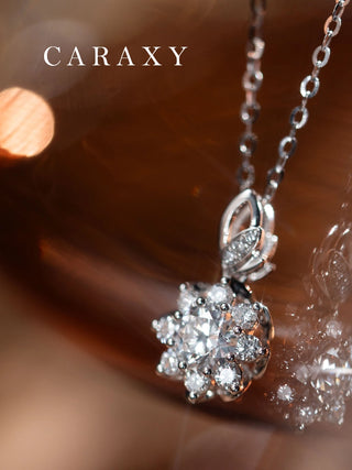 Close-up of a lab grown diamond flower pendant necklace in 18K white gold with a sparkling floral halo design.