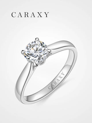 Classic four-prong solitaire engagement ring with a tapered band by CARAXY.