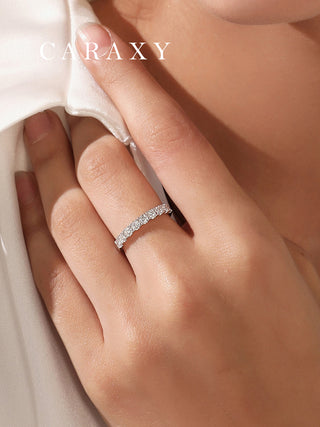 Woman wearing a lab grown diamond half eternity wedding band on her finger