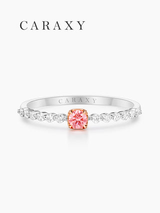 Front view of a half pavé engagement ring with a pink round center stone and round shared-prong diamonds