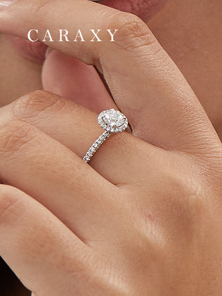 Detailed lifestyle view of a round halo diamond ring on model's hand.