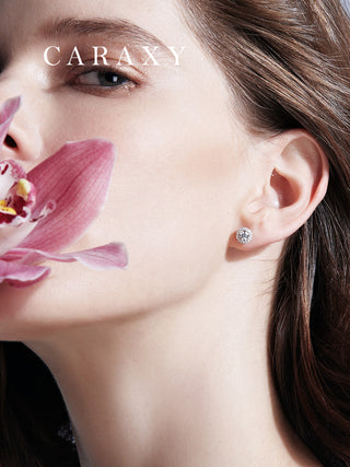 Model wearing halo lab-grown diamond stud earrings with elegant floral styling.