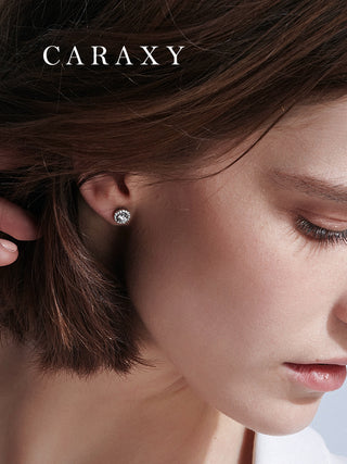 Model wearing round halo lab-grown diamond stud earrings in a close-up ear view.