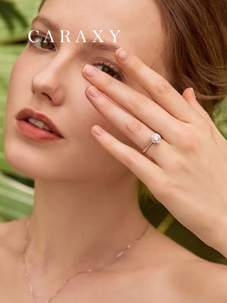 Close-up of high profile setting engagement ring worn on model's hand.