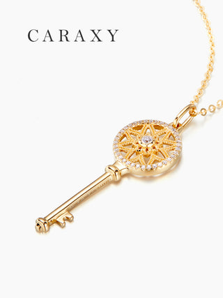 Angle view of diamond key necklace in 18K yellow gold