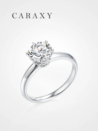 A minimalist knife edge solitaire engagement ring with a round brilliant diamond.