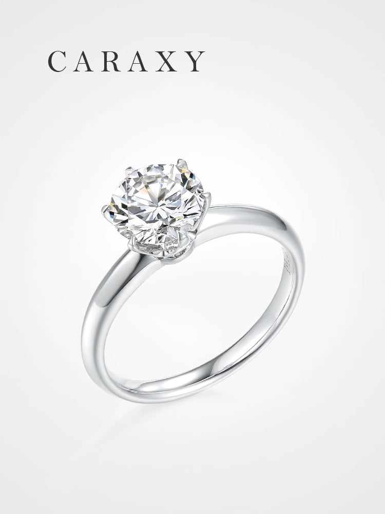A minimalist knife edge solitaire engagement ring with a round brilliant diamond.