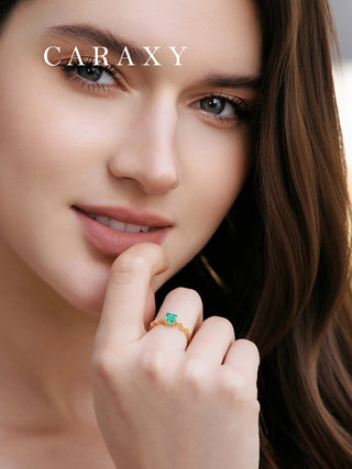 Model wearing lab created emerald ring.