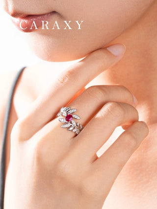 Model wearing a lab created ruby statement ring with sparkling botanical leaf details.