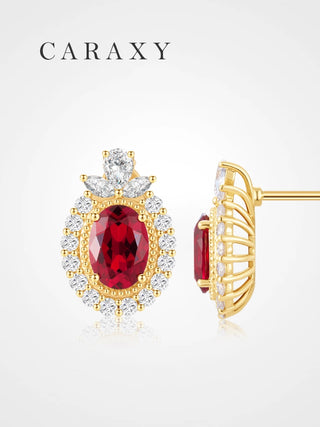 Lab created ruby stud earrings in 18K yellow gold with diamond halo.