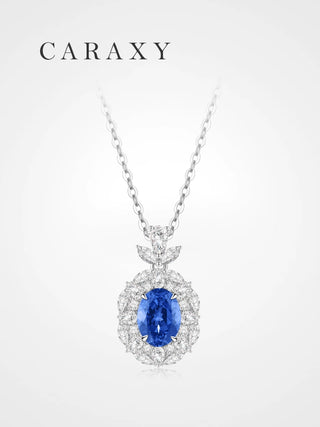 Lab created sapphire birthstone necklace in 18K white gold with cornflower blue oval sapphire and floral diamond halo.