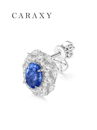 Angled back view of a lab created sapphire halo stud earring in 18K white gold, showing the oval blue sapphire, diamond halo, post, butterfly push back, and CARAXY detail.