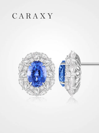 Front view of lab created sapphire stud earrings in 18K white gold, featuring oval cornflower blue sapphires with pear and marquise lab grown diamond halos.