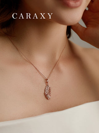 Model wearing a lab grown diamond feather necklace with a delicate pendant for an elegant everyday look.