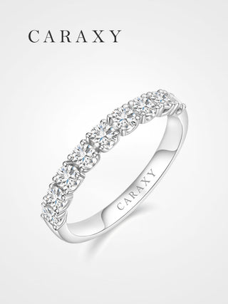 Angled view of a lab grown diamond half eternity wedding band with a round shared-prong design