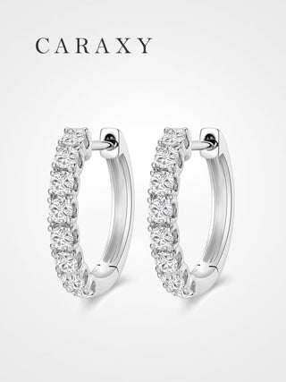 Lab grown diamond huggie hoop earrings in 18K white gold with round diamonds.
