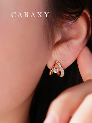 Model wearing lab grown diamond open huggie earrings in 18K yellow gold.