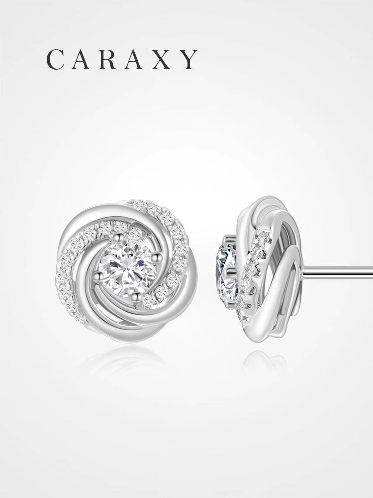 Lab grown diamond swirl stud earrings in 18K white gold shown from front and side.